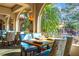 Elegantly appointed dining room with tables set for fine dining and views of swaying palm trees at 9220 San Jose Blvd, Howey In The Hills, FL 34737