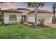 Charming single-story home boasts a tile roof, manicured lawn, and lush landscaping at 9220 San Jose Blvd, Howey In The Hills, FL 34737