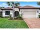 Charming single-Gathering home with a well-kept lawn, mature landscaping, and a brick driveway at 9220 San Jose Blvd, Howey In The Hills, FL 34737