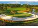 Beautiful golf course with a sand trap, green, pond, and surrounding trees on a sunny day at 9220 San Jose Blvd, Howey In The Hills, FL 34737
