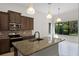 Well-lit kitchen boasts stainless appliances, granite counters, and a center island with seating at 9220 San Jose Blvd, Howey In The Hills, FL 34737