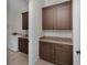 Laundry room with wood cabinets, a washer and dryer and a granite countertop at 9220 San Jose Blvd, Howey In The Hills, FL 34737