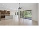 Open living space with tiled floors and a wall of sliding glass doors to the lanai at 9220 San Jose Blvd, Howey In The Hills, FL 34737