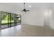 Bright living space with tiled floors and wall of sliding glass doors to the lanai at 9220 San Jose Blvd, Howey In The Hills, FL 34737