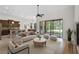 Staged open living space with tiled floors and access to the screened-in lanai at 9220 San Jose Blvd, Howey In The Hills, FL 34737