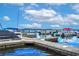 Beautiful marina featuring boats docked along piers with calm water and clear skies on a sunny day at 9220 San Jose Blvd, Howey In The Hills, FL 34737
