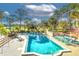Large in-ground pool surrounded by mature trees, lounge chairs, and umbrellas for relaxing poolside at 9220 San Jose Blvd, Howey In The Hills, FL 34737