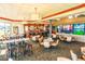 Spacious restaurant featuring a full bar, dining tables, televisions and views of surrounding green space at 9220 San Jose Blvd, Howey In The Hills, FL 34737