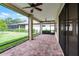 A screened patio with brick flooring overlooks a beautifully maintained yard in a private setting at 9220 San Jose Blvd, Howey In The Hills, FL 34737