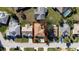 Overhead view of a charming single-story home surrounded by well-kept lawns and mature trees at 9430 Se 176Th Saffold St, The Villages, FL 32162