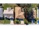 Overhead view of a charming single-story home surrounded by well-kept lawns and mature trees at 9430 Se 176Th Saffold St, The Villages, FL 32162
