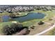 Stunning aerial view of the golf course community with lush landscaping and serene lake views at 9430 Se 176Th Saffold St, The Villages, FL 32162