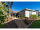 Beautifully landscaped backyard features a stone path and lush garden at 9430 Se 176Th Saffold St, The Villages, FL 32162