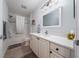 Bathroom features a shower-tub combination and a white vanity with ample storage and a large mirror at 9430 Se 176Th Saffold St, The Villages, FL 32162
