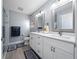 Elegant bathroom with double vanity, framed mirrors, modern fixtures, and a glass enclosed shower at 9430 Se 176Th Saffold St, The Villages, FL 32162