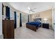 Cozy bedroom featuring luxury vinyl plank flooring, ample natural light, and a ceiling fan at 9430 Se 176Th Saffold St, The Villages, FL 32162
