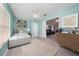 Bright bedroom with neutral tones, plush rug, and a view into the cozy living room space at 9430 Se 176Th Saffold St, The Villages, FL 32162