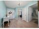 Inviting foyer with a view into the bedroom and bathroom with luxury vinyl plank flooring at 9430 Se 176Th Saffold St, The Villages, FL 32162