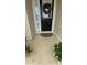 Welcoming front porch with a decorated door and a neutral-toned mat, framed by greenery at 9430 Se 176Th Saffold St, The Villages, FL 32162