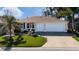 Charming single-story home featuring a manicured lawn and a spacious three-car garage at 9430 Se 176Th Saffold St, The Villages, FL 32162