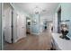 Hallway with luxury vinyl plank flooring, leading to bathroom, laundry, and living areas at 9430 Se 176Th Saffold St, The Villages, FL 32162