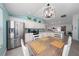 Eat-in kitchen boasts modern appliances, granite countertops, and a stylish dining area with pendant lighting at 9430 Se 176Th Saffold St, The Villages, FL 32162