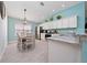 Well-lit kitchen and breakfast nook with granite counters, stainless steel appliances, and pendant lighting at 9430 Se 176Th Saffold St, The Villages, FL 32162