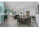 Open-concept living and dining area featuring neutral décor, vaulted ceilings, and natural light at 9430 Se 176Th Saffold St, The Villages, FL 32162