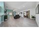 Spacious living room with vaulted ceiling, large sliding glass doors, and neutral color palette at 9430 Se 176Th Saffold St, The Villages, FL 32162