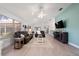 Bright living room boasts vaulted ceilings, updated flooring, and comfortable seating around a modern entertainment center at 9430 Se 176Th Saffold St, The Villages, FL 32162