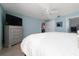 Comfortable bedroom featuring plush bed, dresser, and convenient access to the ensuite bathroom and closets at 9430 Se 176Th Saffold St, The Villages, FL 32162