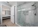 Modern walk-in shower with glass enclosure, seating, and stylish tile work at 9430 Se 176Th Saffold St, The Villages, FL 32162