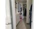 Organized walk-in closet featuring built-in shelves and rods, designed for efficient storage at 9430 Se 176Th Saffold St, The Villages, FL 32162