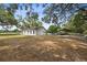 Backyard view of the home with an attached carport, fenced yard and fresh exterior paint at 9483 Cr 747, Webster, FL 33597
