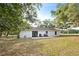 Spacious backyard featuring a concrete patio, grill and lush greenery at 9483 Cr 747, Webster, FL 33597