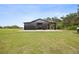 Exterior of the spacious black barn situated in a large grassy field at 9483 Cr 747, Webster, FL 33597
