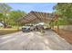 Carport with a metal roof, concrete floor and covered parking for multiple vehicles at 9483 Cr 747, Webster, FL 33597