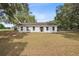 Charming single-story home with a large front yard and mature trees, freshly painted at 9483 Cr 747, Webster, FL 33597
