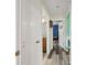 Hallway with doors leading to a full bathroom and a bedroom with baseball theme at 9483 Cr 747, Webster, FL 33597