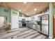 Open kitchen with stainless steel appliances, modern cabinetry, and adjacent living space at 9483 Cr 747, Webster, FL 33597