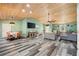 Spacious living room with wood-look flooring, vaulted ceilings and a ceiling fan at 9483 Cr 747, Webster, FL 33597