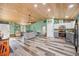Open living room concept connecting to kitchen, wood-look flooring and natural lighting at 9483 Cr 747, Webster, FL 33597