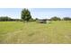Expansive pasture with mature trees, fencing and horse shelter under a clear blue sky at 9483 Cr 747, Webster, FL 33597