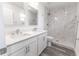 Modern bathroom featuring double sinks, white marble-look tiled shower, and updated fixtures at Lot 21 Indian Estates Cr 423, Lake Panasoffkee, FL 33538
