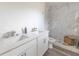 Elegant bathroom features double sinks, quartz countertop, sleek fixtures and a glass enclosed marble shower at Lot 21 Indian Estates Cr 423, Lake Panasoffkee, FL 33538