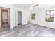 Bright bedroom with luxury vinyl plank flooring, a ceiling fan, and a view of the lush greenery at Lot 21 Indian Estates Cr 423, Lake Panasoffkee, FL 33538