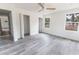 Spacious bedroom with light walls, modern ceiling fan and two large windows at Lot 21 Indian Estates Cr 423, Lake Panasoffkee, FL 33538