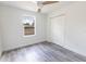 Cozy bedroom with bright walls, sleek ceiling fan, modern vinyl floors and large closet space at Lot 21 Indian Estates Cr 423, Lake Panasoffkee, FL 33538