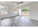 Bedroom with bright walls, sleek ceiling fan, modern vinyl floors and sliding glass door to backyard at Lot 21 Indian Estates Cr 423, Lake Panasoffkee, FL 33538