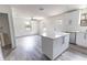 Open-concept living space features a kitchen island, modern cabinetry, and seamless flow to the living room at Lot 21 Indian Estates Cr 423, Lake Panasoffkee, FL 33538